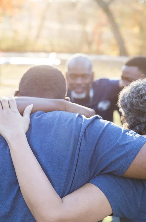 Group of people supporting each other outdoors 