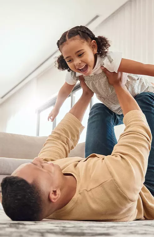 Family at home playing in living room