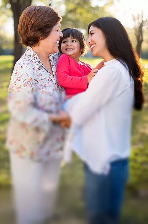 Grandmother outside with daughter and granddaughter