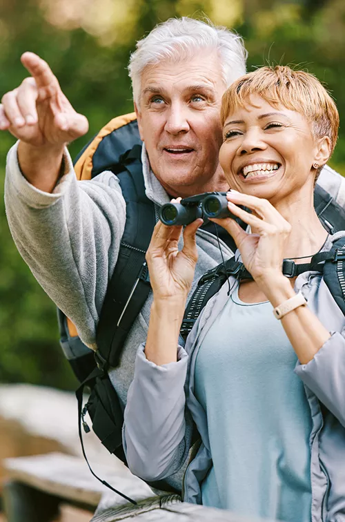 Older couple bird watching together.