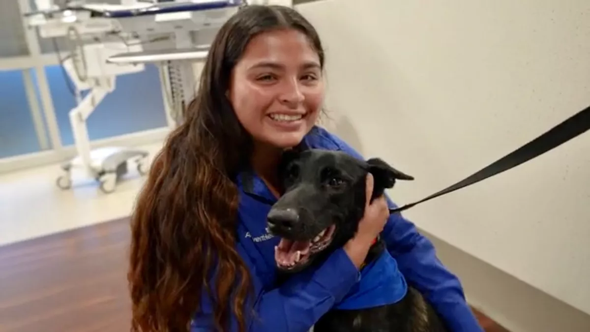 An AdventHealth team member with Recon the therapy dog