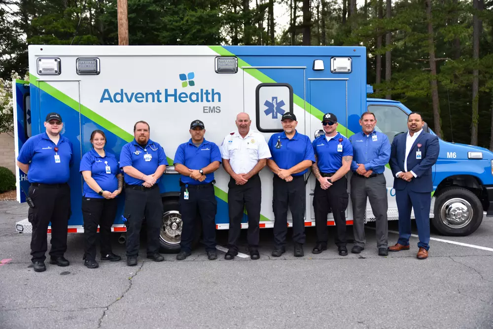 EMS Team stands in front of new ambulance