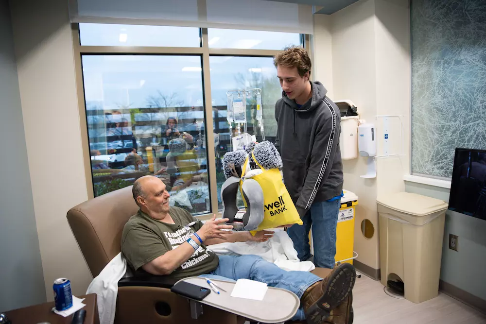 Student gives care bag to cancer patient