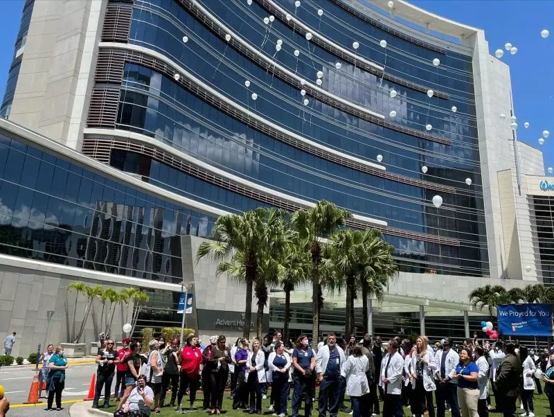 AdventHealth team members in Orlando, Florida gather outside for a time of prayer.