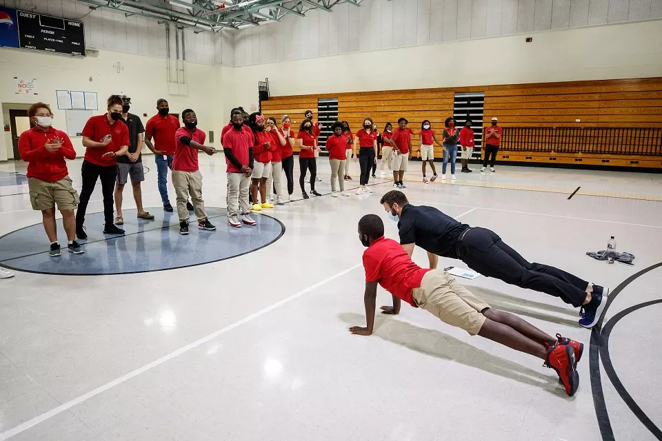 AdventHealth physical therapist does pushups with students 