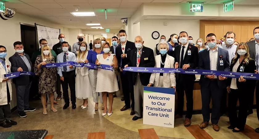: Accompanied by hospital staff and members of the community, AdventHealth DeLand CEO David Weis cuts the ribbon on the campus’s new Transitional Care Unit.