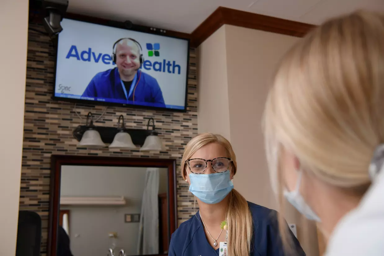 A virtual nurse comes on the television in a patient's room at AdventHealth Deland.