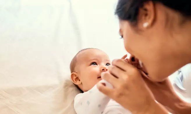 mother kisses a baby's hands peek-a-boo adventhealth gordon