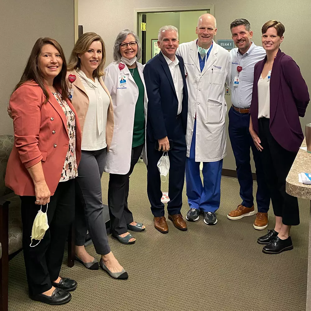 Dr. Girard stands with AdventHealth leadership and physician support team.