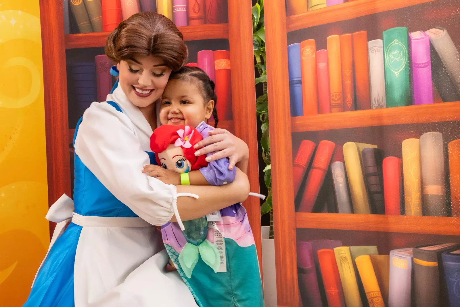 Disney Princess Belle hugs a young patient at AdventHealth for Children.