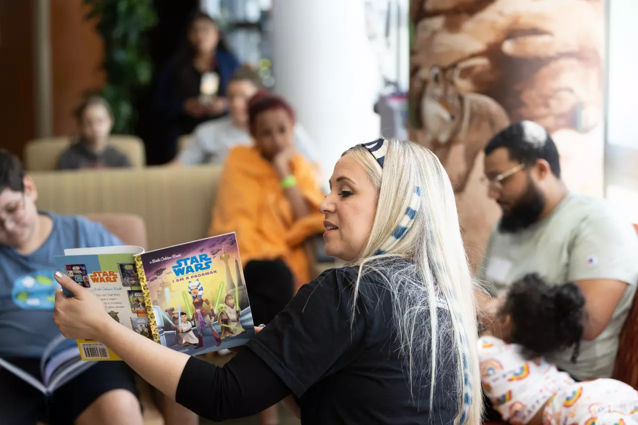 Ashley Eckstein, voice of voice of Star Wars’ Ahsoka Tano, reads to patients at AdventHealth for Children.