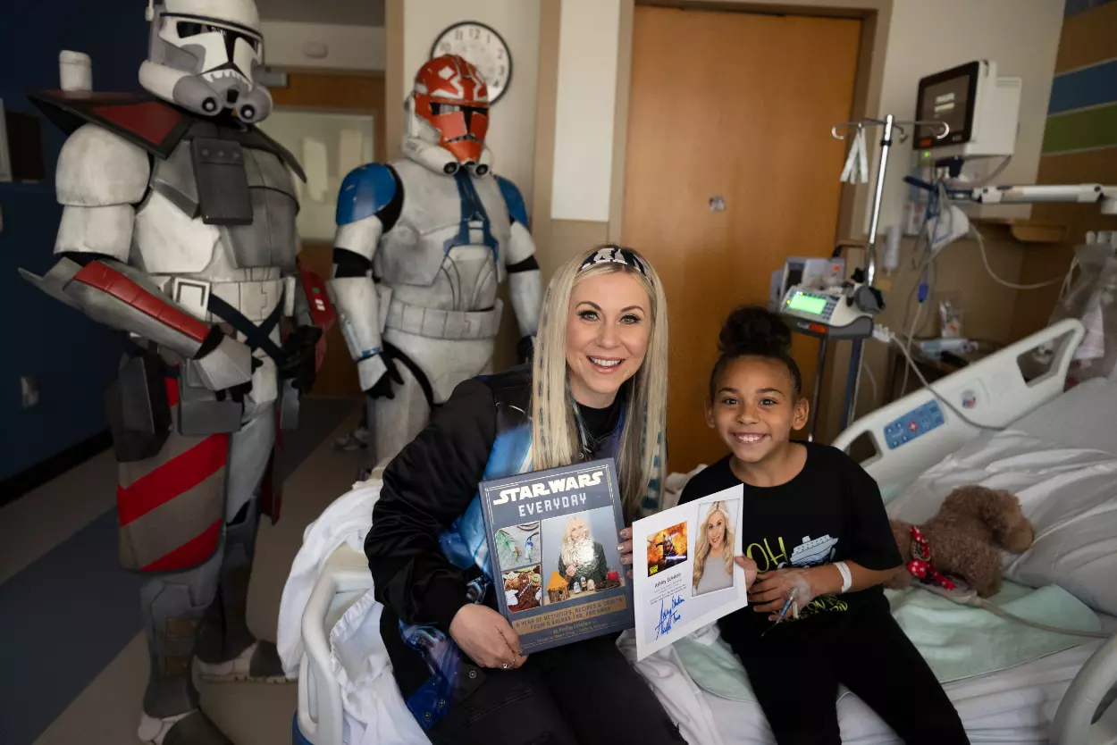 Ashley Eckstein, voice of voice of Star Wars’ Ahsoka Tano, reads to a patient at AdventHealth for Children.