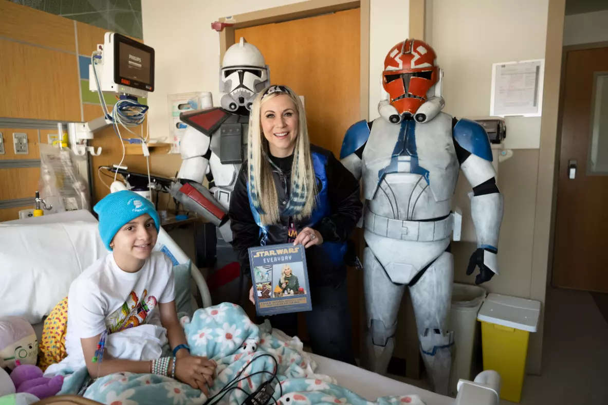 Ashley Eckstein, voice of voice of Star Wars’ Ahsoka Tano, reads to a patient at AdventHealth for Children.