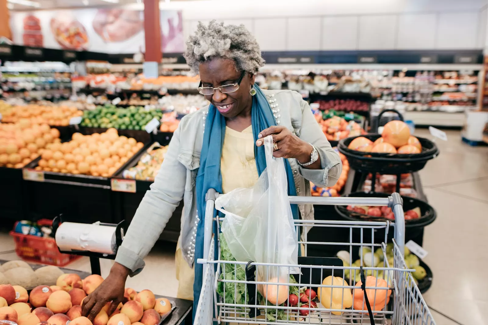 Older woman shopping for produce at the grocery store