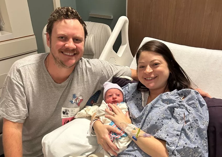 Parents hold their new baby who was born during Hurricane Milton.