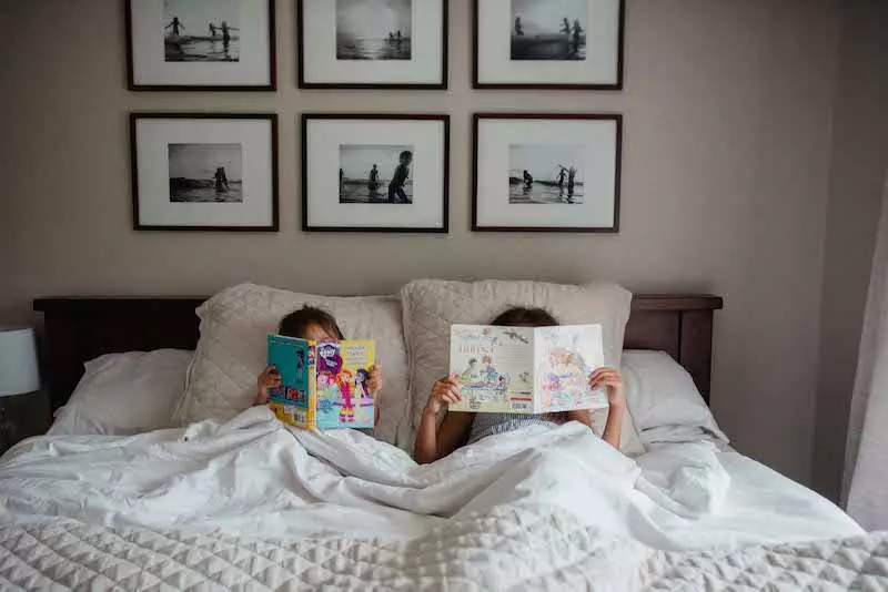 Children in bed reading