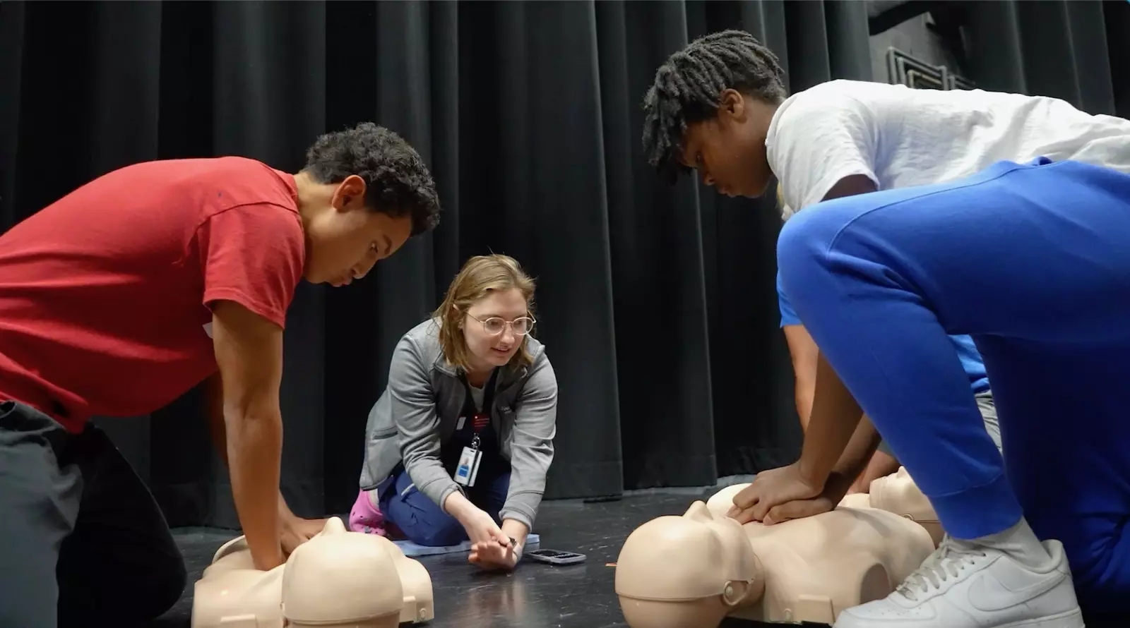 An AdventHealth team member teaches hands-only CPR to Lyman High School students