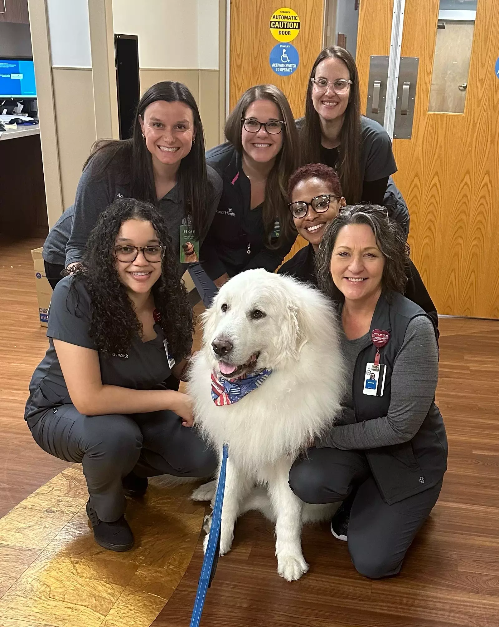 Pet therapy volunteer Duke McDreamy and AdventHealth team members.