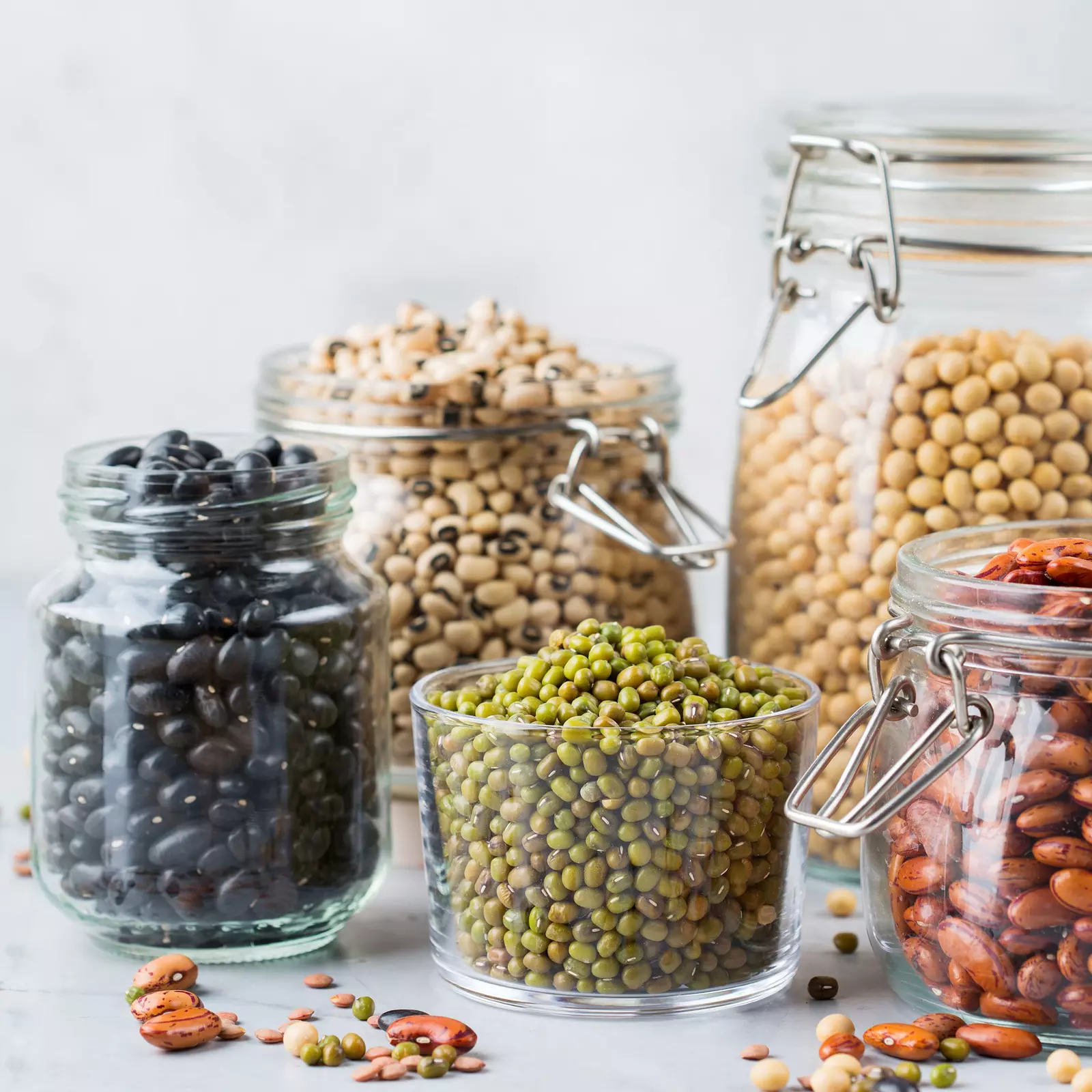 A photo of several jars holding a variety of beans