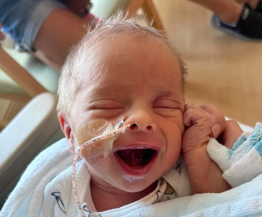 Baby Archer Hanson smiles at the camera from the NICU at AdventHealth Celebration.