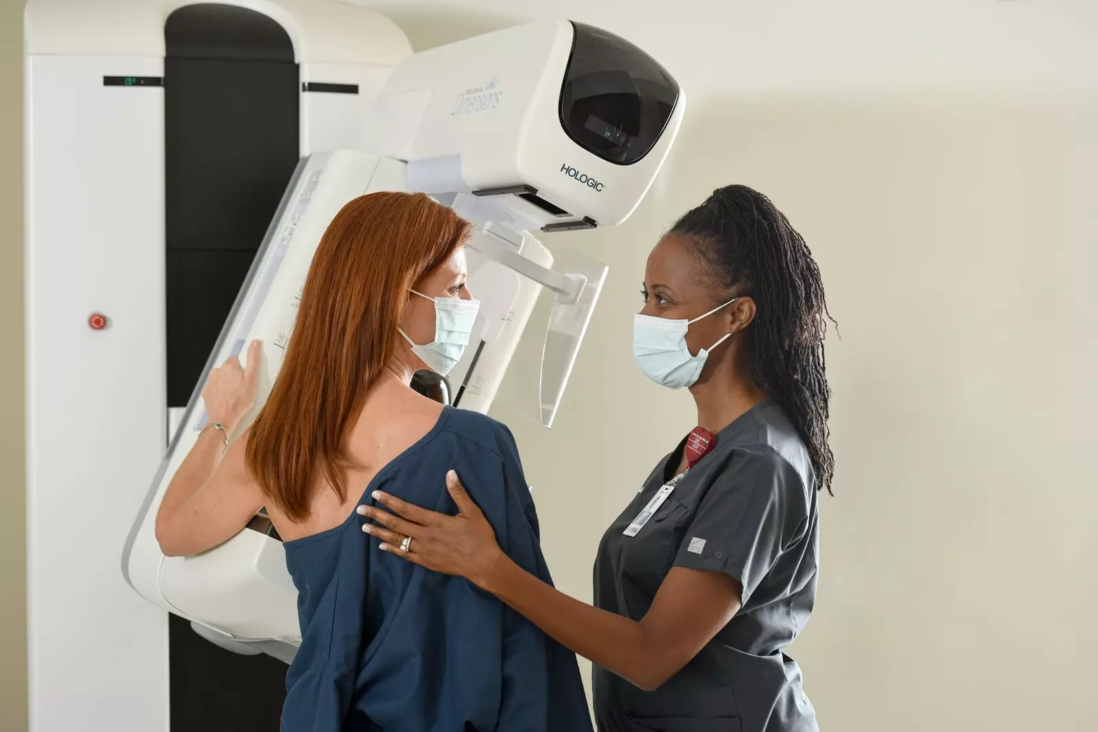 nurse helping patient with mammogram
