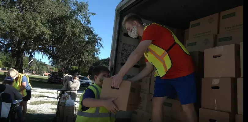 Volunteers unload a truck of food at the Hope Center