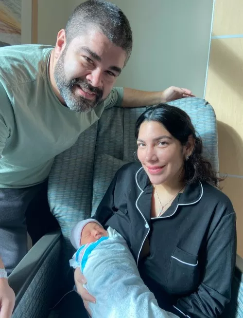 Parents hold their new baby who was born during Hurricane Milton.