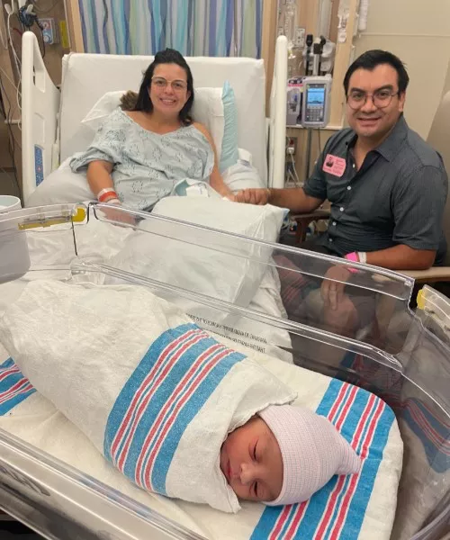 Parents with their new baby who was born during Hurricane Milton.