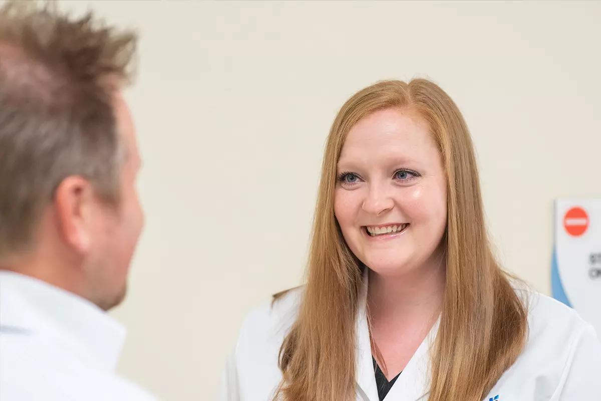 A nurse called, Tiffany Kelley, talking with a patient.