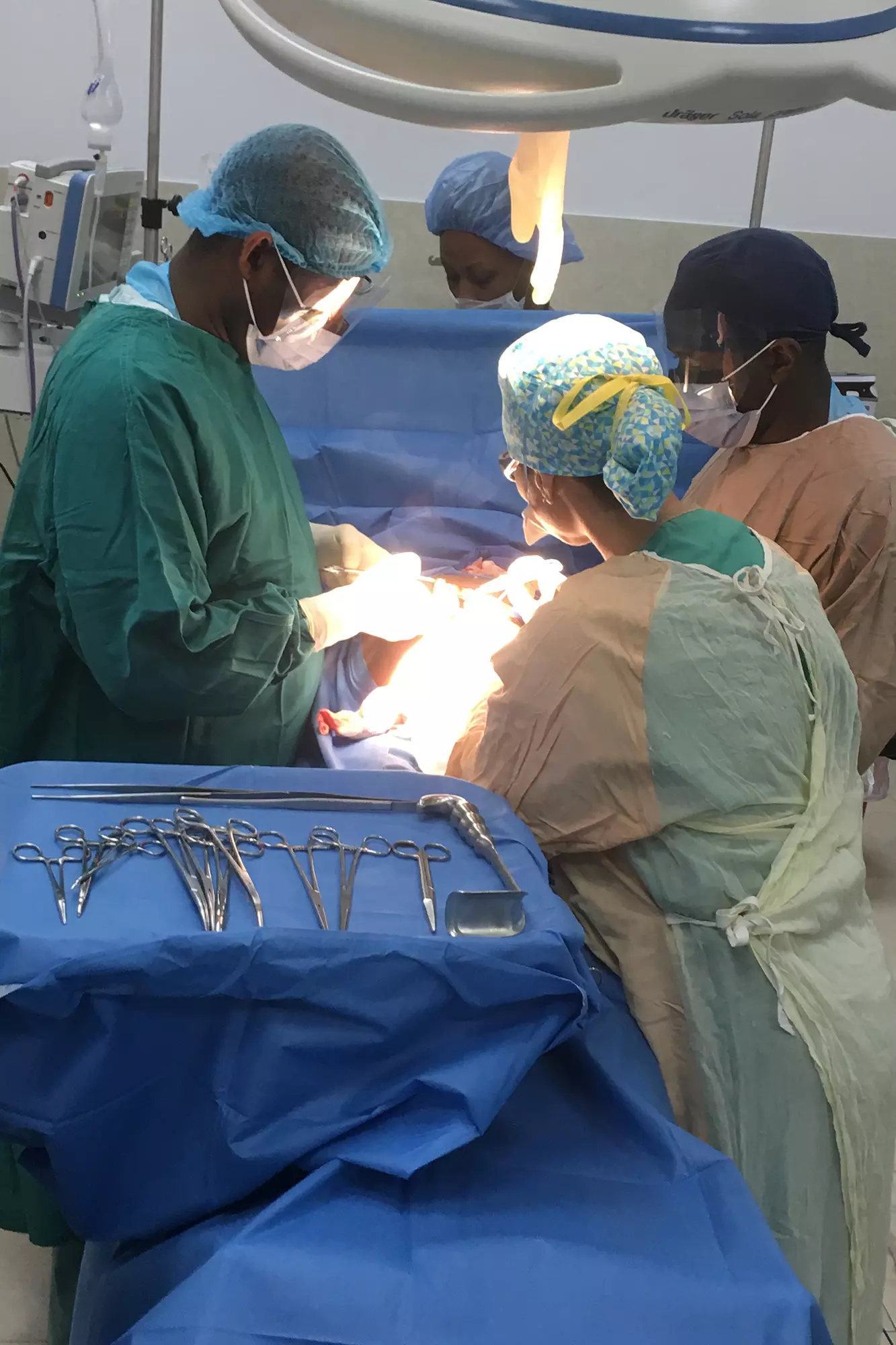 Dr. McKenzie’s (in yellow scrubs) last mission trip to Haiti to lend her surgical expertise to other physicians in an effort to mentor local professionals and improve healthcare in the country.