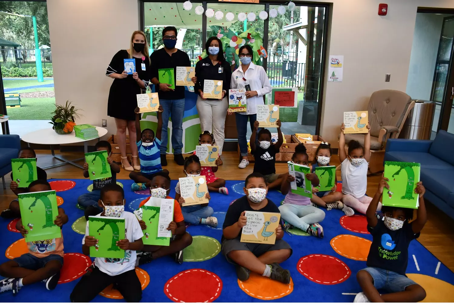 a photo of children holding up books