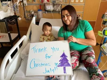 a patient and parent holding a thank you card