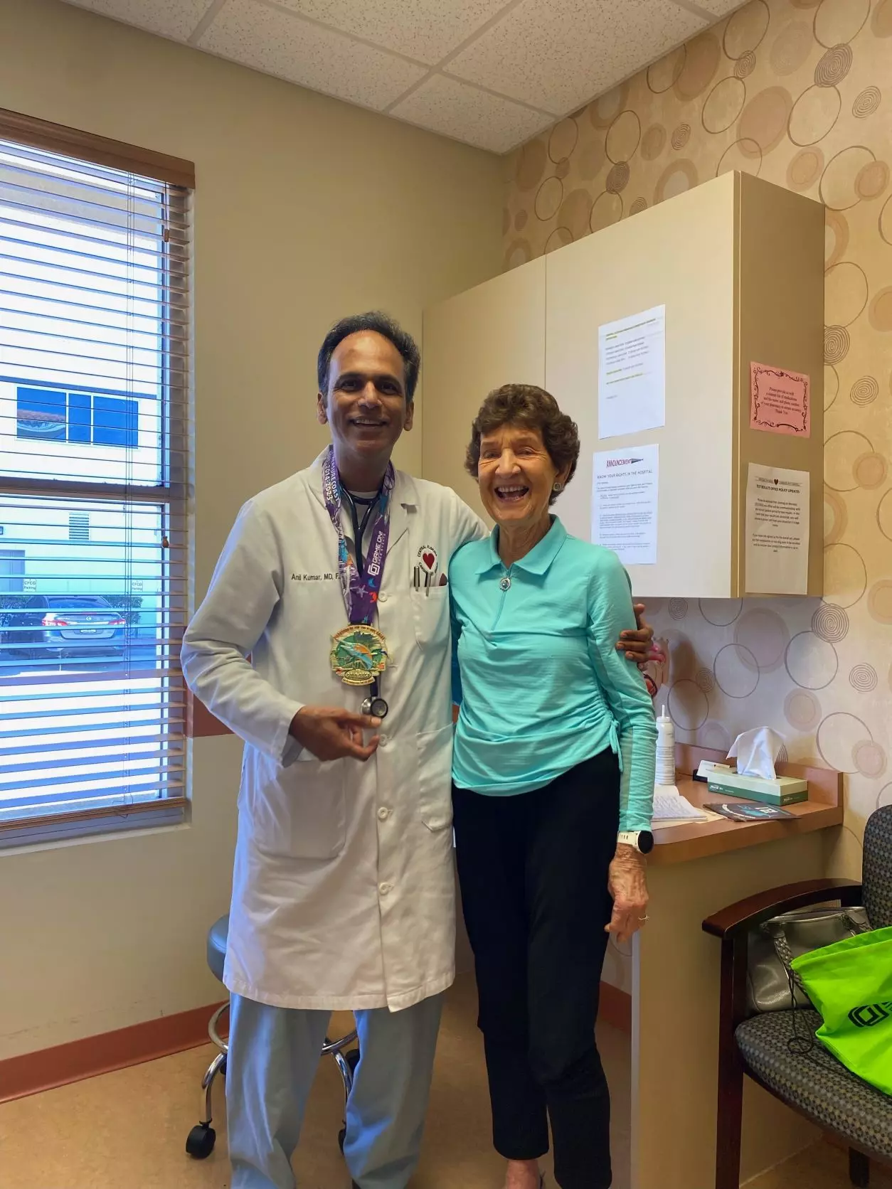 87-year-old marathoner honors Dr. Kumar with race medal. 