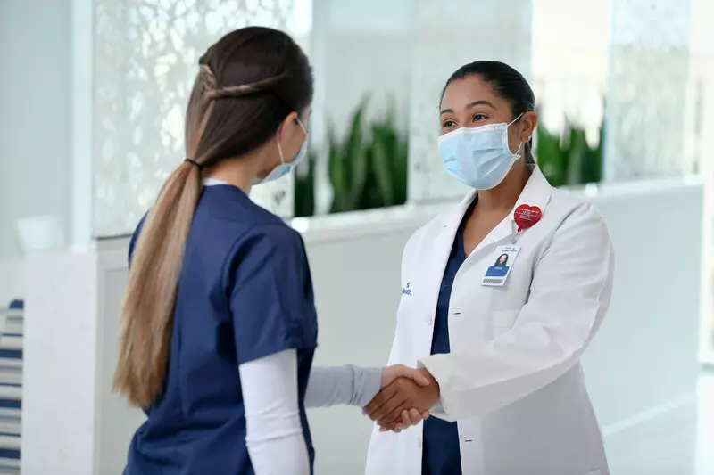 Nurse and physician shaking hands