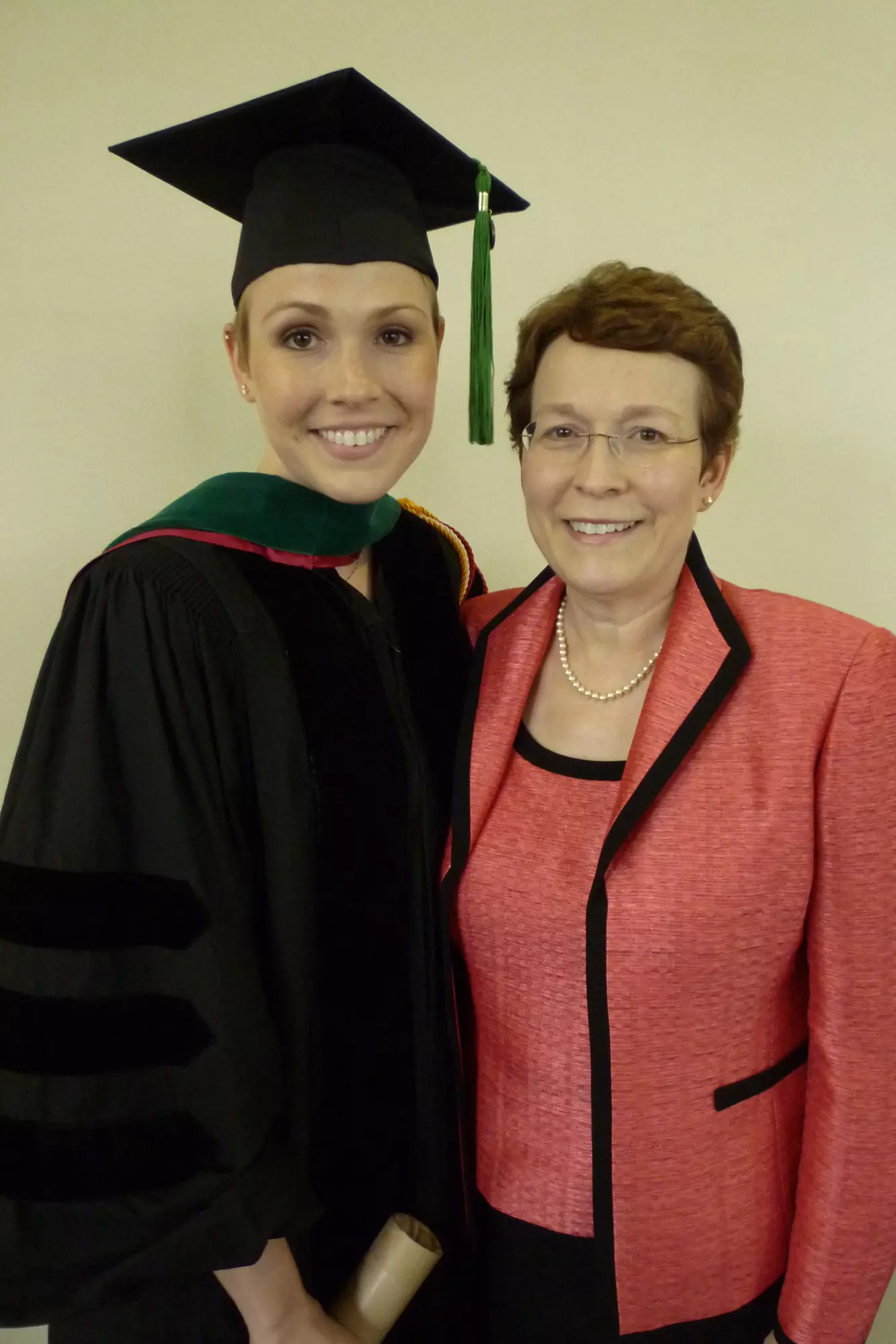 Dr. Orman's mom proudly stands by her daughter at her medical school graduation.