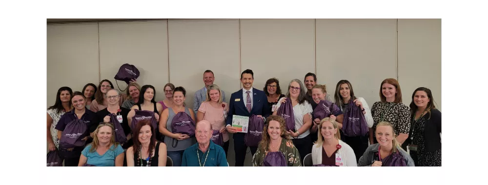 Nurses holding new backpacks for parents