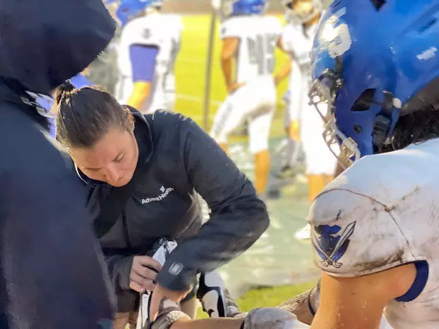AdventHealth athletic trainer providing care during Matanzas High School’s football game 