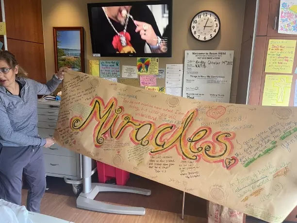 nurses holding. a miracles sign