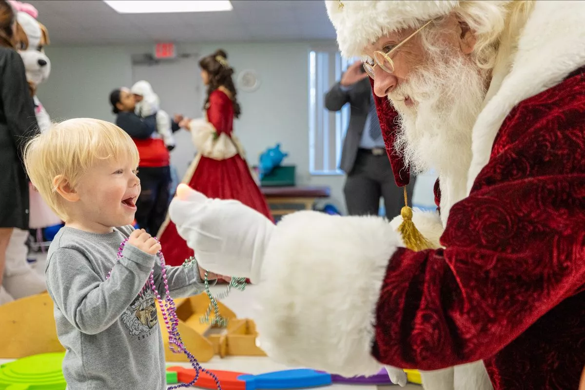 Santa visits AdventHealth Ocala Pediatric Rehab Patient.