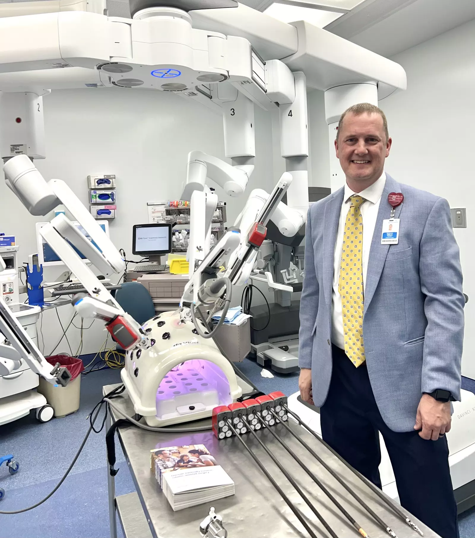 Dr. Matthew Wilson next to the da Vinci XI Robotic Surgical System™