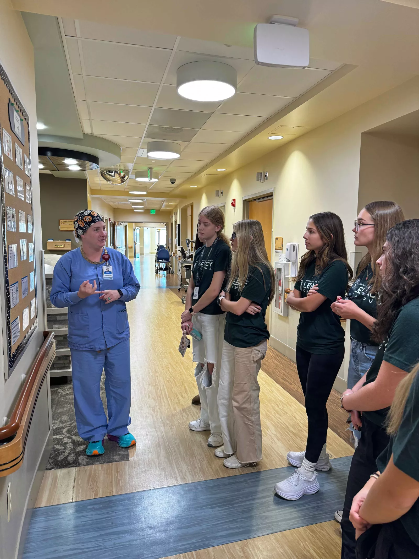 Students listen to a nurse while touring AdventHealth Parker