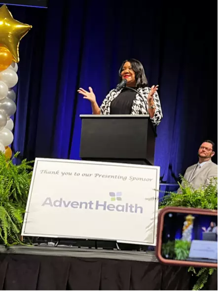Dr. Gregory speaking at an AdventHealth-sponsored event.