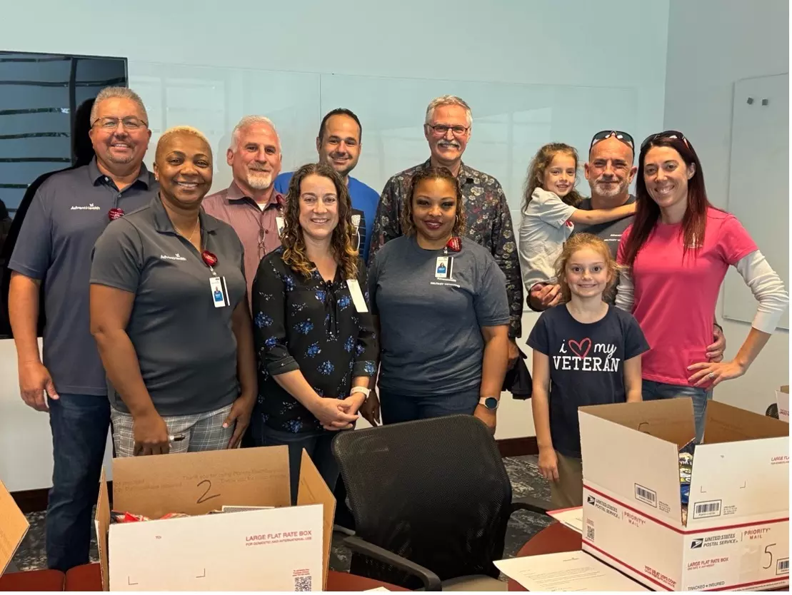 Group of AdventHealth Team members participating in a care package drive for active-duty military.